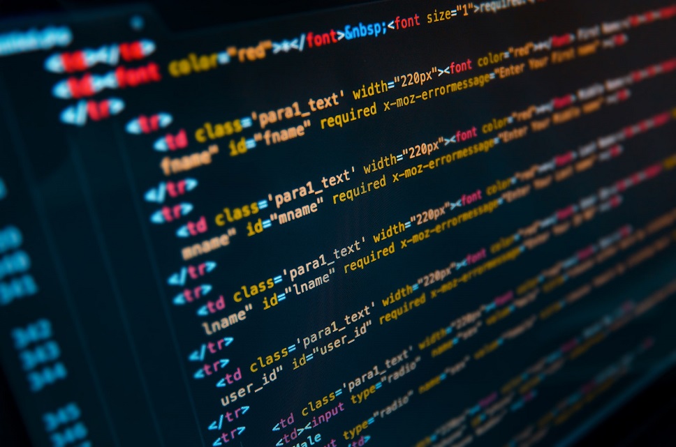 Close-up view of computer code on a screen, highlighting HTML and CSS syntax for web development.